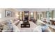 Open-concept living room with a fireplace, neutral furnishings, and connection to the dining area at 7030 Butternut Oak Ter, Huntersville, NC 28078