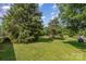 Lush backyard featuring a green lawn, mature trees and lush surroundings at 7785 Crestwood Dr, Kannapolis, NC 28081