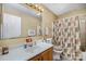Bathroom with a large mirror, toilet, and a shower with patterned shower curtain at 7785 Crestwood Dr, Kannapolis, NC 28081