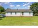 Rear exterior of single story home with blue siding, sliding glass door, and a large backyard at 7785 Crestwood Dr, Kannapolis, NC 28081