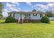 Charming single-story home with a welcoming front porch and landscaped yard, perfect for suburban living at 7785 Crestwood Dr, Kannapolis, NC 28081