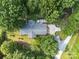 An aerial view of the house with a deck, driveway, and is surrounded by lush greenery and mature trees at 8101 Truelight Church Rd, Mint Hill, NC 28227