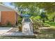Landscaped backyard featuring an accessible ramp to the deck, ideal for outdoor living and relaxation at 8101 Truelight Church Rd, Mint Hill, NC 28227