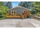 Wooden deck with stairs, offering outdoor seating and surrounded by lush greenery at 8101 Truelight Church Rd, Mint Hill, NC 28227