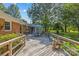 Spacious wooden deck perfect for outdoor entertaining, complete with dining set and lush backyard view at 8101 Truelight Church Rd, Mint Hill, NC 28227