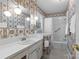 Full bathroom with floral wallpaper, white vanity, and a shower-tub combination at 8101 Truelight Church Rd, Mint Hill, NC 28227