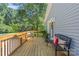 Inviting deck with wooden railings, bench seating, and charming decor offers a relaxing outdoor space at 8101 Truelight Church Rd, Mint Hill, NC 28227