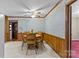 A cozy dining room with wood accents, wallpaper detail, and a ceiling fan at 8101 Truelight Church Rd, Mint Hill, NC 28227