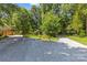 Gravel driveway leading to a home surrounded by lush trees and landscaping at 8101 Truelight Church Rd, Mint Hill, NC 28227