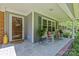 Close-up of a charming front porch with rocking chairs, decorative plants, and a wreath at 8101 Truelight Church Rd, Mint Hill, NC 28227