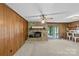 Cozy living room with a stone fireplace, wood paneling, and a bar area at 8101 Truelight Church Rd, Mint Hill, NC 28227