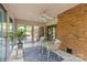 Inviting sunroom with brick accents, a ceiling fan, and sliding glass doors to outdoor space at 8101 Truelight Church Rd, Mint Hill, NC 28227