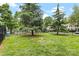 Spacious common area with lush green lawn and mature trees, perfect for outdoor activities at 9606 Vinca Cir # E, Charlotte, NC 28213