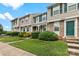 Well-kept townhomes with vibrant green doors and shutters, framed by lush landscaping at 9606 Vinca Cir # E, Charlotte, NC 28213