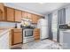 Kitchen featuring wood cabinets, stainless steel appliances, and light blue walls at 9606 Vinca Cir # E, Charlotte, NC 28213