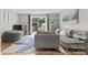 Comfortable living room with large windows, access to outdoor deck, and gray modern furniture at 9606 Vinca Cir # E, Charlotte, NC 28213