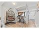 Open-concept living area with gray accents, hardwood floors, and plenty of natural light at 9606 Vinca Cir # E, Charlotte, NC 28213