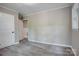 Bedroom with gray vinyl flooring, light gray walls, gray trim, and two white doors at 9763 Pine Tree Ln, Norwood, NC 28128
