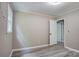 Bedroom with gray vinyl flooring, light gray walls and trim plus two white doors at 9763 Pine Tree Ln, Norwood, NC 28128