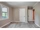 Bedroom with vinyl flooring, light gray walls and trim plus two white doors at 9763 Pine Tree Ln, Norwood, NC 28128