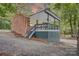 Beautiful brick home featuring a covered porch, steps leading to the yard, and meticulous landscaping at 9763 Pine Tree Ln, Norwood, NC 28128