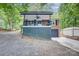 Charming brick home featuring a covered porch with a ceiling fan, and a convenient one-car garage at 9763 Pine Tree Ln, Norwood, NC 28128