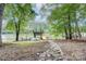 Stone pathway to lake and private dock with boat lift, complete with two kayaks at 9763 Pine Tree Ln, Norwood, NC 28128