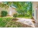 A backyard with a concrete patio and green grass with shrubs at 10132 Caldwell Depot Rd, Cornelius, NC 28031