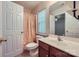 Well-lit bathroom with a single sink, toilet, and shower with a patterned curtain at 10132 Caldwell Depot Rd, Cornelius, NC 28031