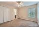 Bright bedroom with a ceiling fan, carpeted floor, closet and natural light at 10132 Caldwell Depot Rd, Cornelius, NC 28031