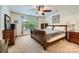 Cozy bedroom with a ceiling fan, plush carpeting, and warm natural lighting at 10132 Caldwell Depot Rd, Cornelius, NC 28031