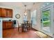 Bright breakfast area features a round table, hardwood floors, and a view of the outdoors at 10132 Caldwell Depot Rd, Cornelius, NC 28031