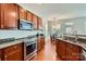 Stylish kitchen features granite counters, stainless appliances, hardwood floors and breakfast area at 10132 Caldwell Depot Rd, Cornelius, NC 28031