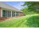 Brick home featuring a screened in porch and well-manicured backyard at 104 Mooreland Ne Dr, Conover, NC 28613