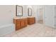 Bathroom with tile floor, double sink vanities, and a walk-in closet at 104 Mooreland Ne Dr, Conover, NC 28613