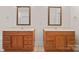 Bathroom featuring double sink vanities, each with framed mirrors and ample storage at 104 Mooreland Ne Dr, Conover, NC 28613