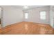 Bright bedroom featuring wood floors, white walls, and large windows at 104 Mooreland Ne Dr, Conover, NC 28613