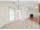 Dining area featuring tile flooring, bright lighting, and many windows overlooking the yard at 104 Mooreland Ne Dr, Conover, NC 28613