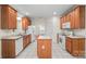 Spacious kitchen equipped with white appliances, tile floors, an island, and wood cabinets at 104 Mooreland Ne Dr, Conover, NC 28613