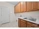 Laundry room with ample cabinet space, a sink, and tile flooring at 104 Mooreland Ne Dr, Conover, NC 28613