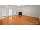Spacious living room with hardwood floors, a fireplace, and access to a patio area at 104 Mooreland Ne Dr, Conover, NC 28613