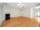 Expansive living room with hardwood floors, a fireplace, and natural light from windows and a door at 104 Mooreland Ne Dr, Conover, NC 28613