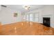 Open living room boasts hardwood floors, recessed lights, a fireplace, and large windows at 104 Mooreland Ne Dr, Conover, NC 28613