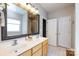 Bright bathroom featuring a double sink vanity, large mirror, and separate shower and toilet areas at 1040 Stonedown Ln, Matthews, NC 28104