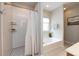 Bright bathroom with separate shower and soaking tub, white fixtures and neutral paint at 1040 Stonedown Ln, Matthews, NC 28104