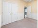 Bedroom with neutral carpet, closet, and doorway open to another room at 1040 Stonedown Ln, Matthews, NC 28104