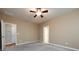 Bedroom with carpet, ceiling fan, neutral paint and doors to closet and bath at 1040 Stonedown Ln, Matthews, NC 28104