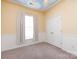 Bright bedroom with a painted sky on the ceiling, large window, closet, and neutral-colored carpet at 1040 Stonedown Ln, Matthews, NC 28104