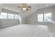 Large bonus room featuring high ceilings, carpet flooring, and plenty of natural light through large windows at 1040 Stonedown Ln, Matthews, NC 28104