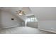 Spacious bonus room with vaulted ceilings, carpet flooring, and ample natural light from large windows at 1040 Stonedown Ln, Matthews, NC 28104